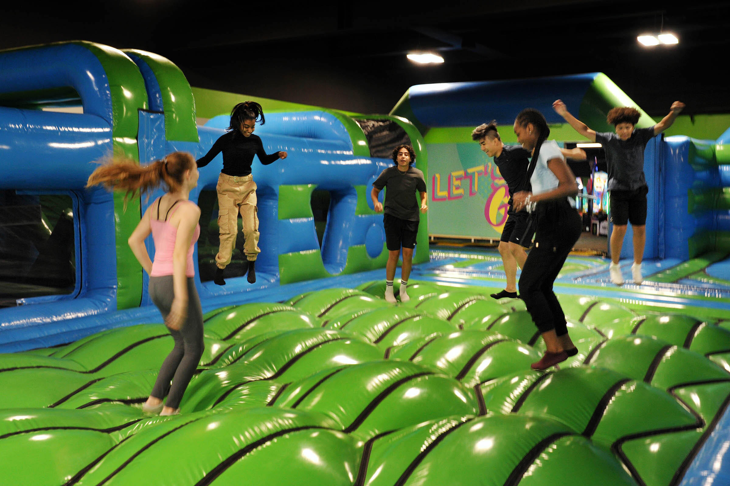 Children having fun, as they jump in an inflatable bounce house.