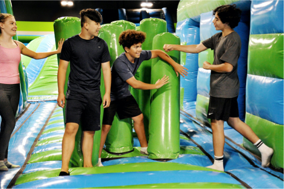 Kids playing by inflatable barriers in an inflatabpark.