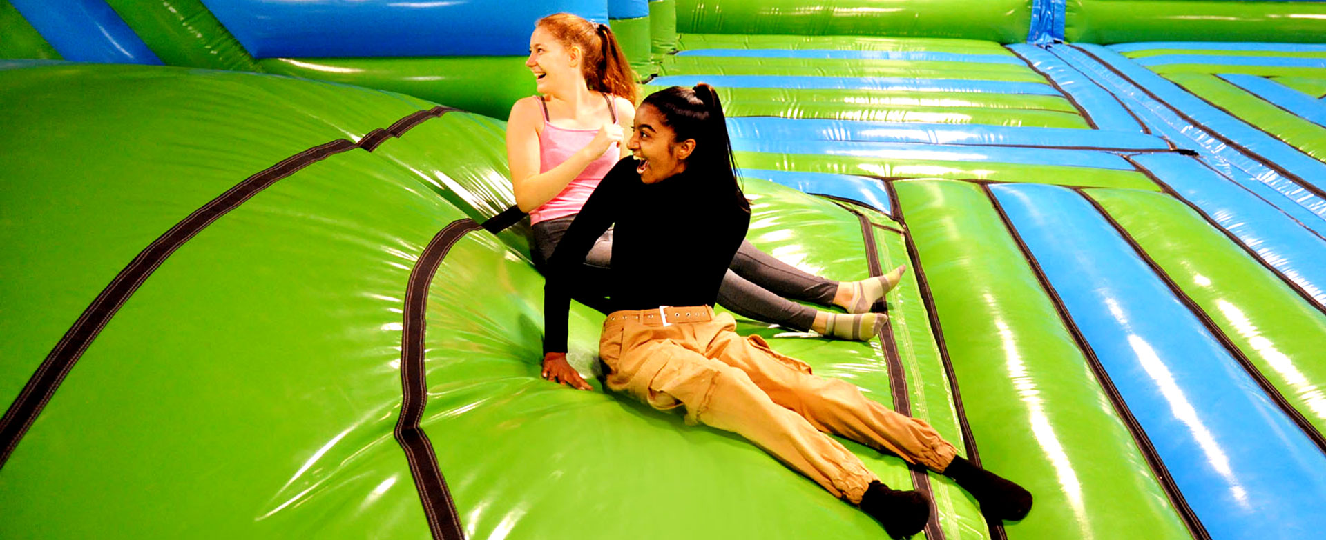 kids having fun bouncy in inflatable park.